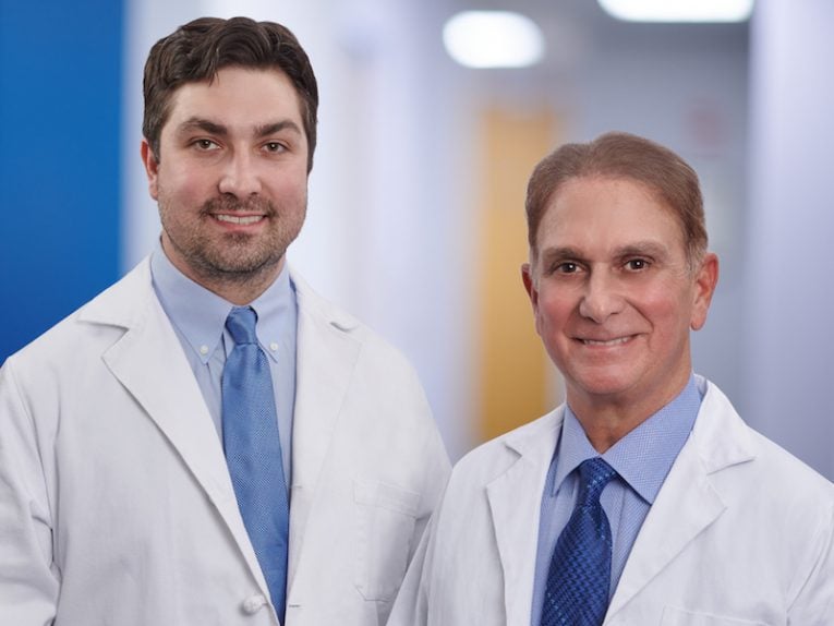 A SMILING PHOTO OF DR. EUGENE M. D’AMICO III & DR. MICHAEL D. D’AMICO, DDS